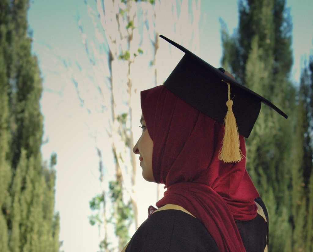 Woman in graduation cap.